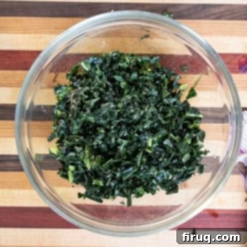 Hearty Kale and White Bean Salad 5 A bowl filled with freshly massaged and chopped kale, ready for the next steps.