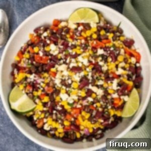 Tex-Mex Treasure Salad 8 A close-up shot of a creamy and colorful Cowboy Caviar Salad in a rustic bowl, garnished with fresh cilantro and lime, highlighting the vibrant beans and vegetables.