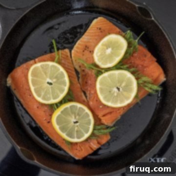 Perfectly Seared Cast Iron Lemon Dill Salmon 5 Salmon searing in cast iron with lemon and dill on top