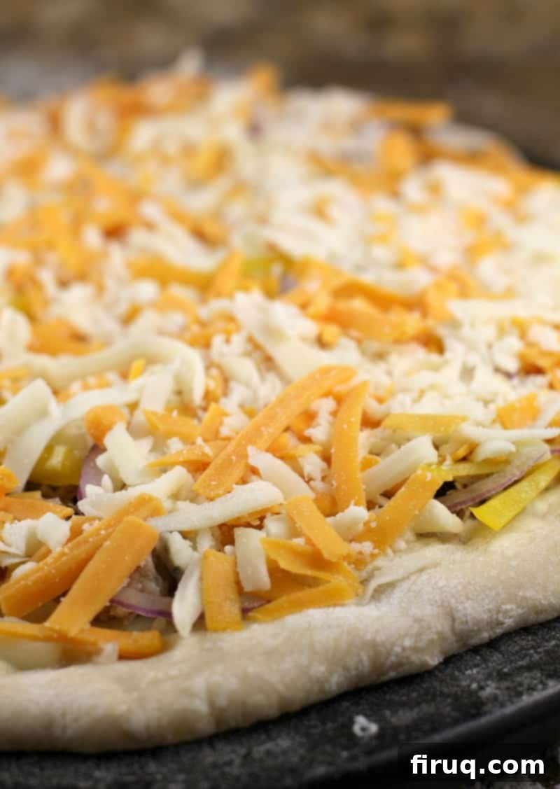 Texas BBQ Pizza 8 cheeses on an uncooked pizza