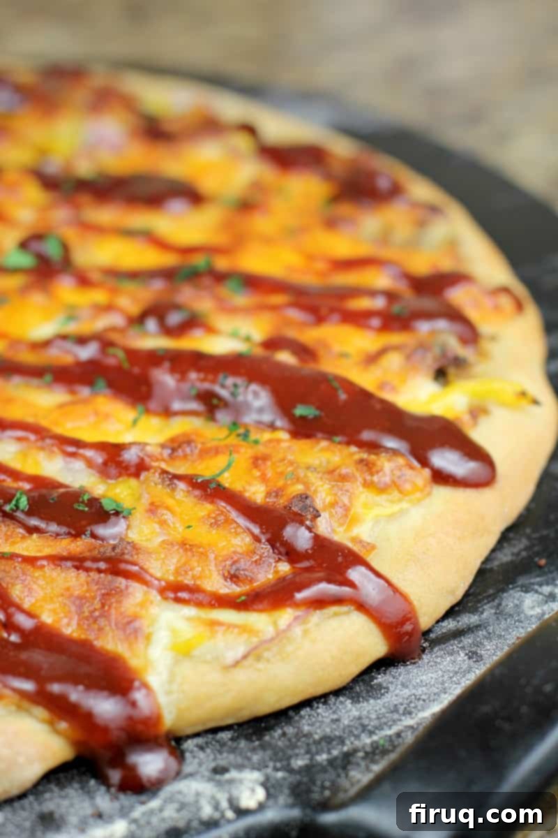 Texas BBQ Pizza 10 cooked pizza on pizza stone drizzled with sauce