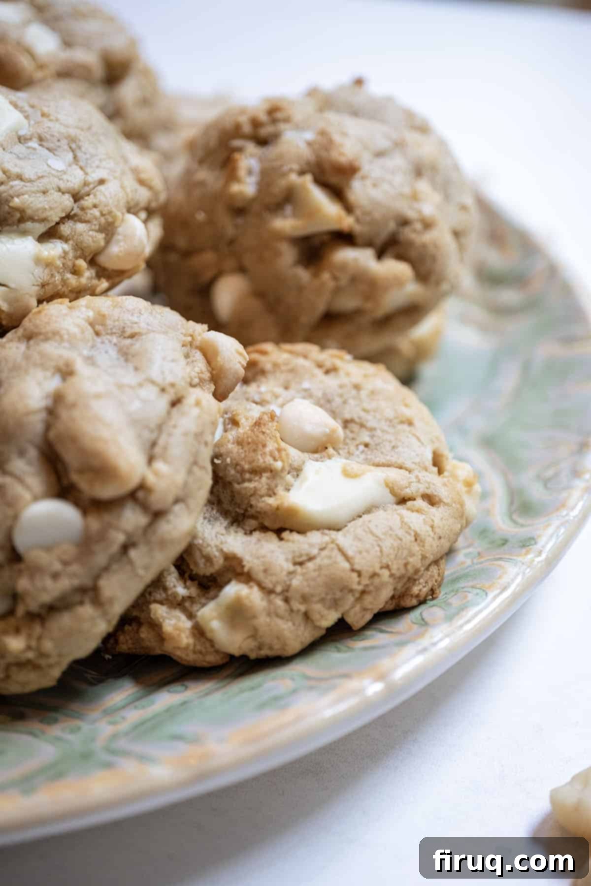 Irresistible Chewy White Chocolate Macadamia Nut Cookies 11 White chocolate macadamia nut cookies on a plate.