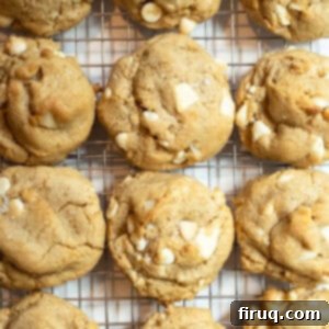 Irresistible Chewy White Chocolate Macadamia Nut Cookies 12 White chocolate macadamia nut cookies on a cooling rack.