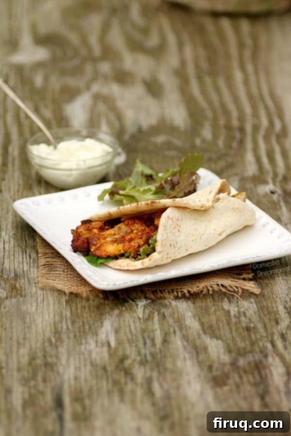 Plated Homemade Chicken Shawarma with fresh toppings Chicken Shawarma Pita