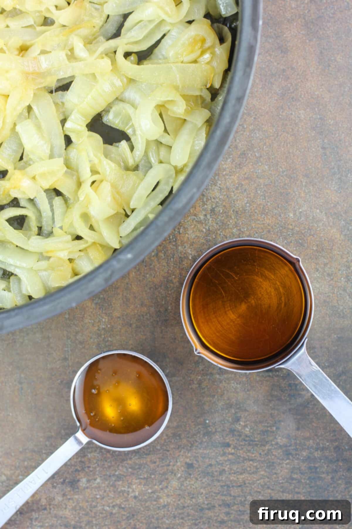 Sticky Honey Bourbon Onions 6 Measuring cups containing bourbon whiskey and honey, ready to be added to the caramelized onions.