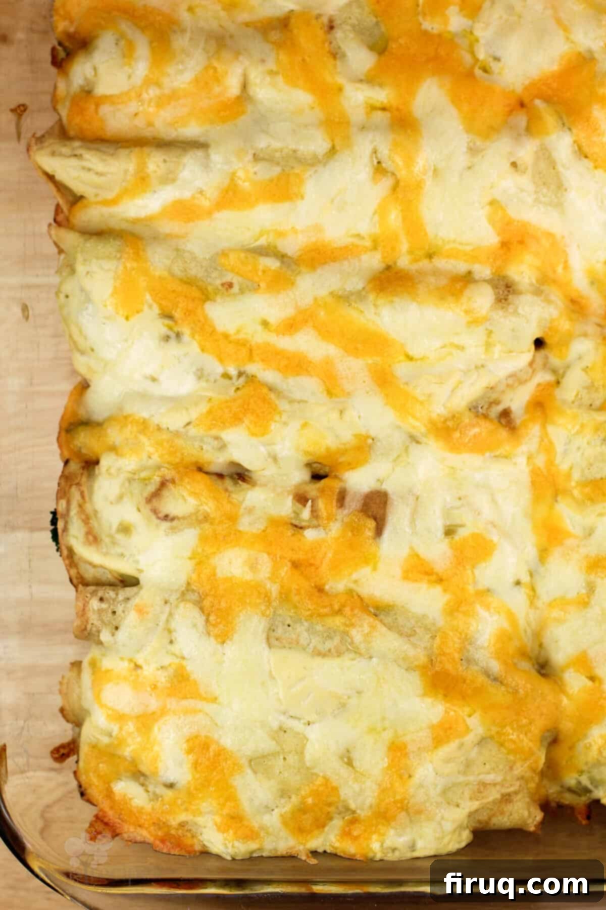 Beer-Infused Broccoli Cheese Crepes 4 cooked crepes topped with cheese in glass bake dish.