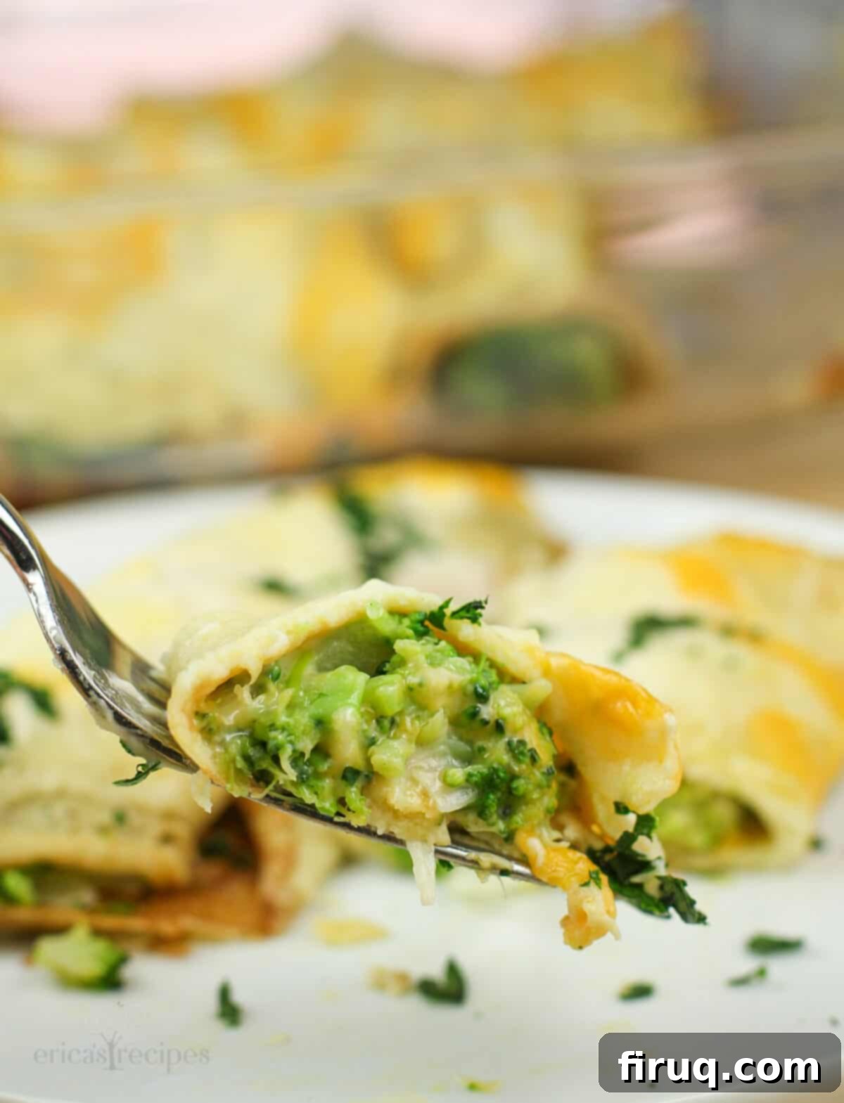 Beer-Infused Broccoli Cheese Crepes 5 fork holding bite of crepe to show broccoli filling.
