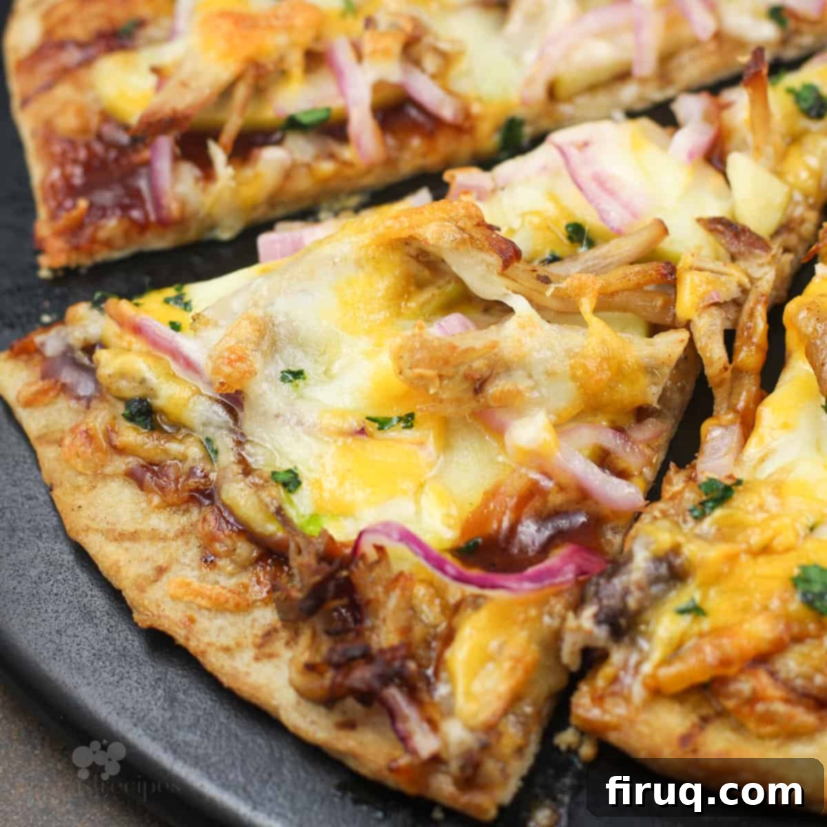 Pulled Pork & Apple Pizza 2 slice of pork and apple pizza on black pizza stone.