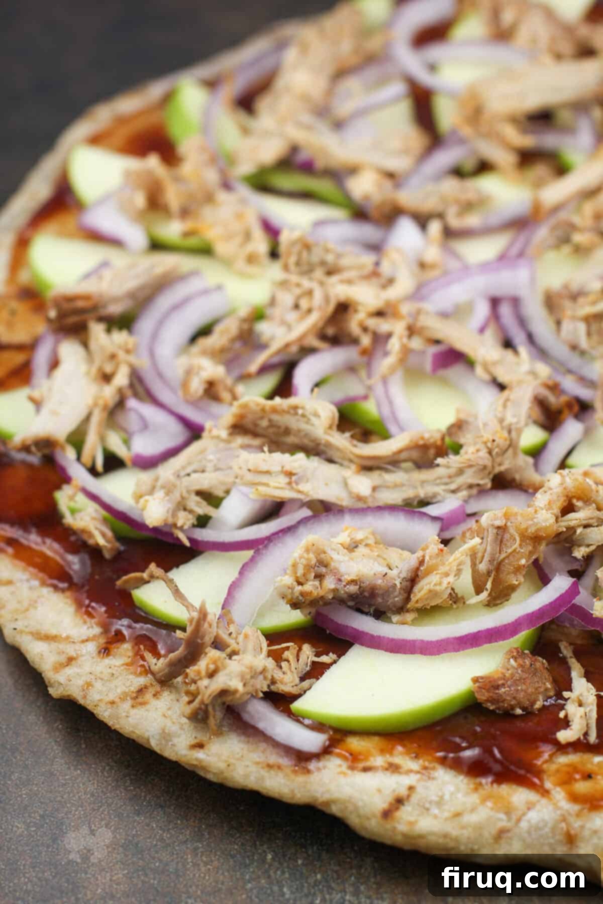 Pulled Pork & Apple Pizza 3 pizza toppings on crust before adding cheese.