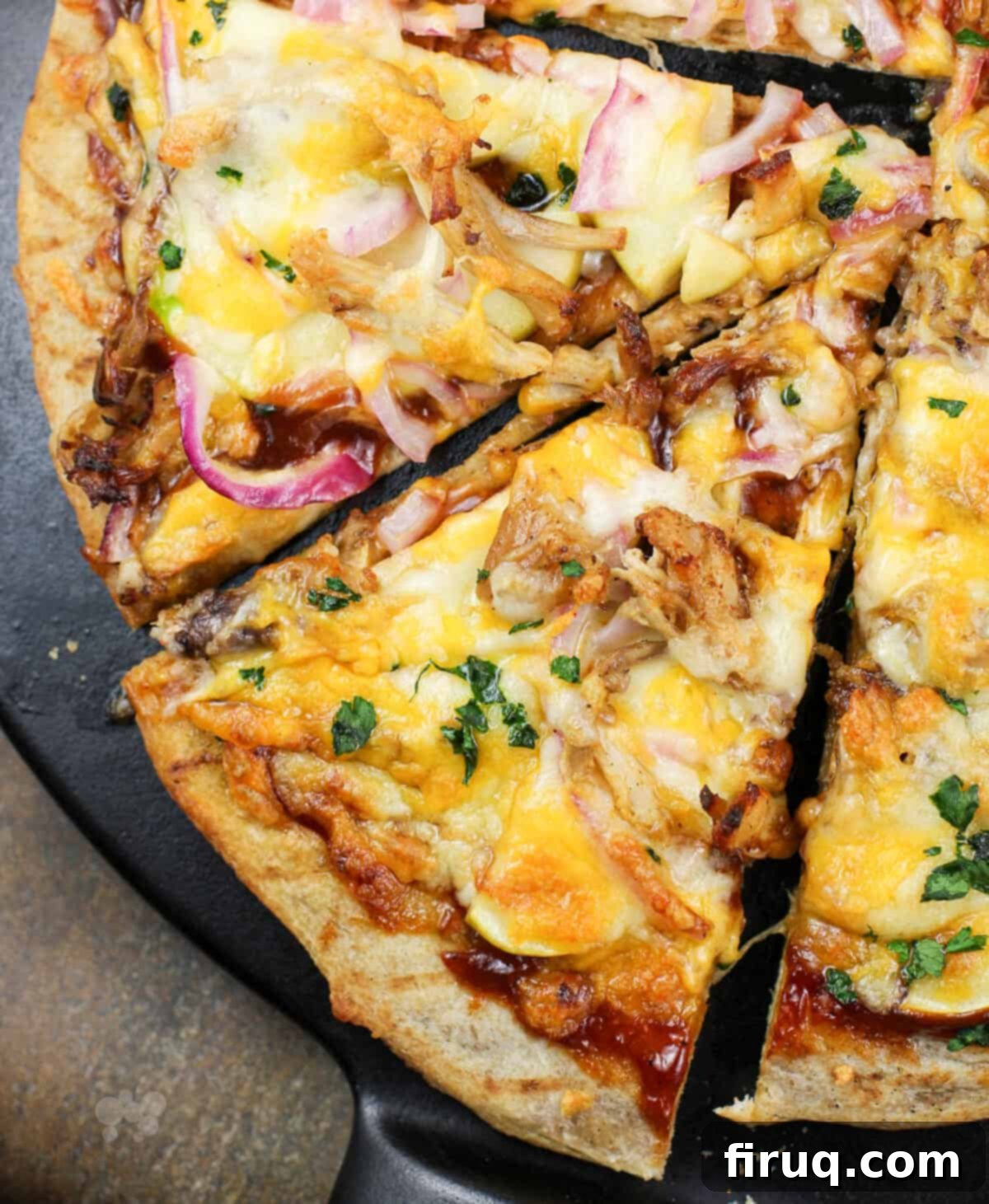Pulled Pork & Apple Pizza 4 slice of pizza on black pizza stone.