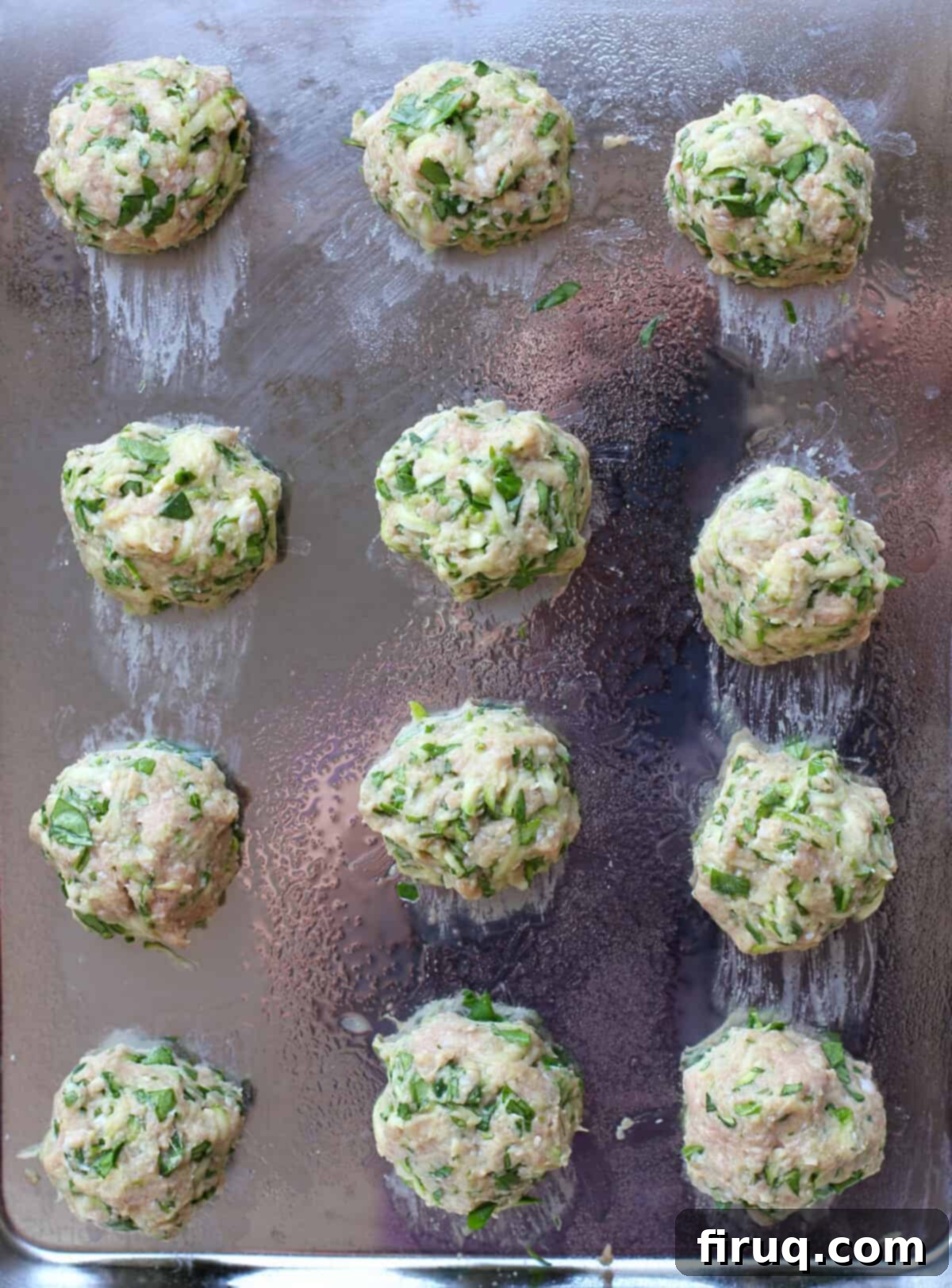 Wholesome Turkey Zucchini Meatballs 5 uncooked meatballs on bake sheet