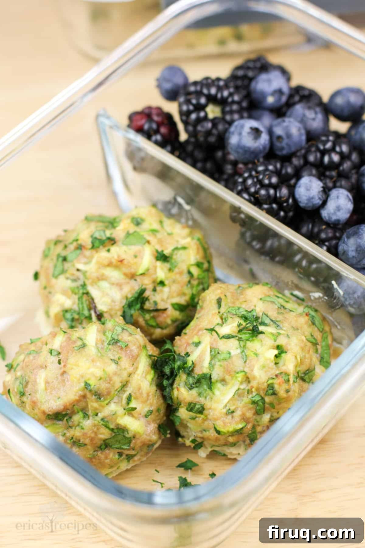Wholesome Turkey Zucchini Meatballs 7 glass container with 3 cooked meatballs in 1 compartment, blackberries in the other compartment