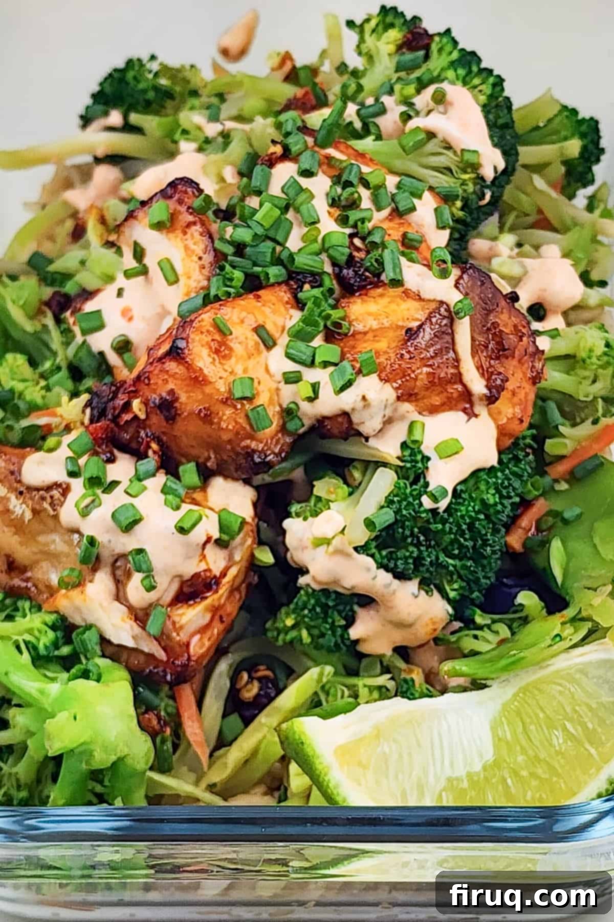 Easy Firecracker Salmon Meal Prep Bowls 5 Four meal prep containers with firecracker salmon, vegetables, and rice, neatly arranged.
