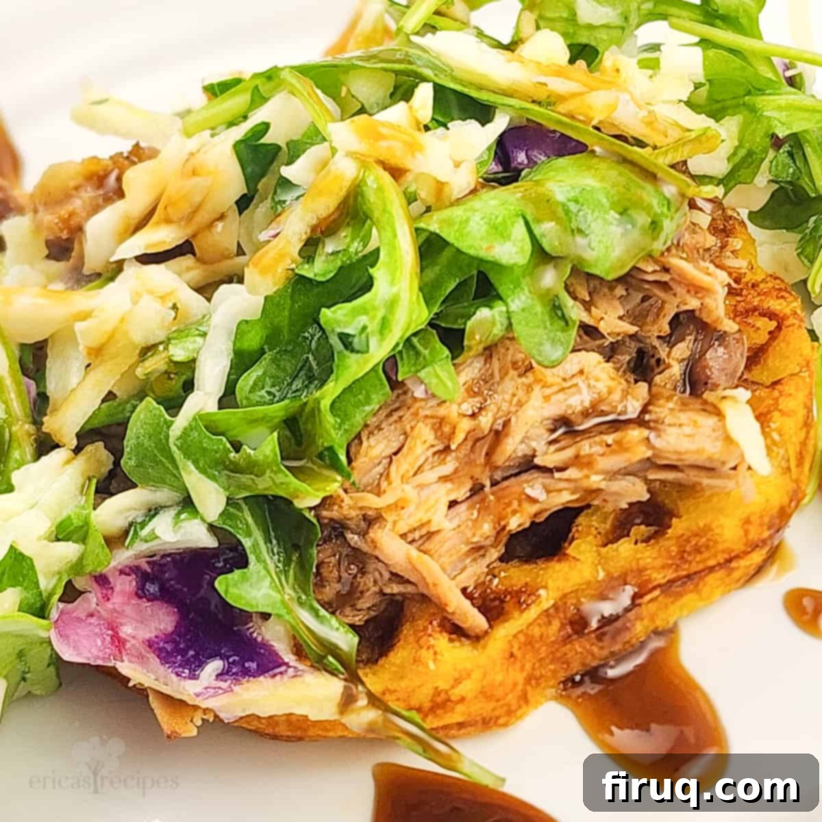 Whiskey-Glazed Pulled Pork on Golden Waffles 2 prepared whiskey pulled pork and waffles topped with apple arugula slaw on white plate, showcasing the rich colors and textures