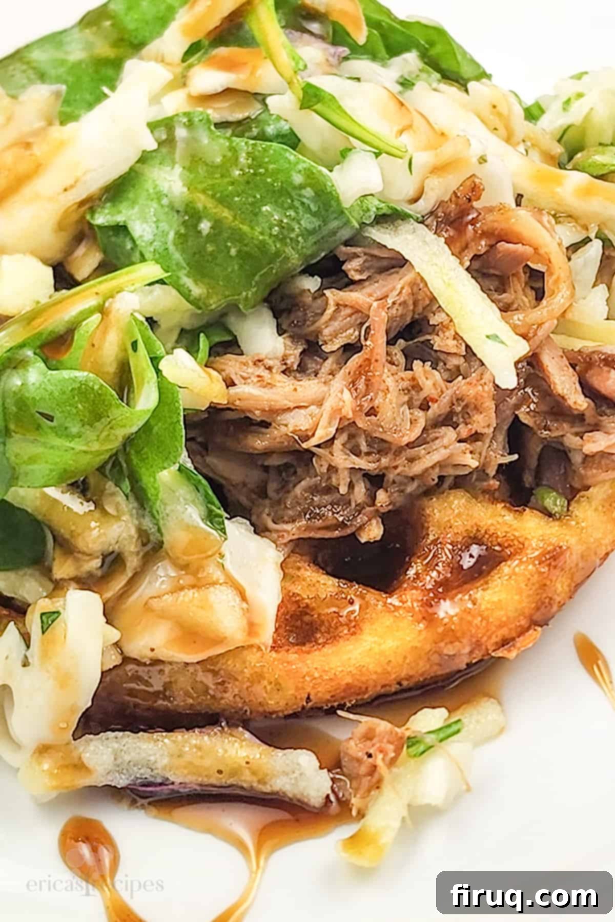 Whiskey-Glazed Pulled Pork on Golden Waffles 4 close-up of prepared pork and waffles recipe on white plate, showing the whiskey honey syrup drizzle