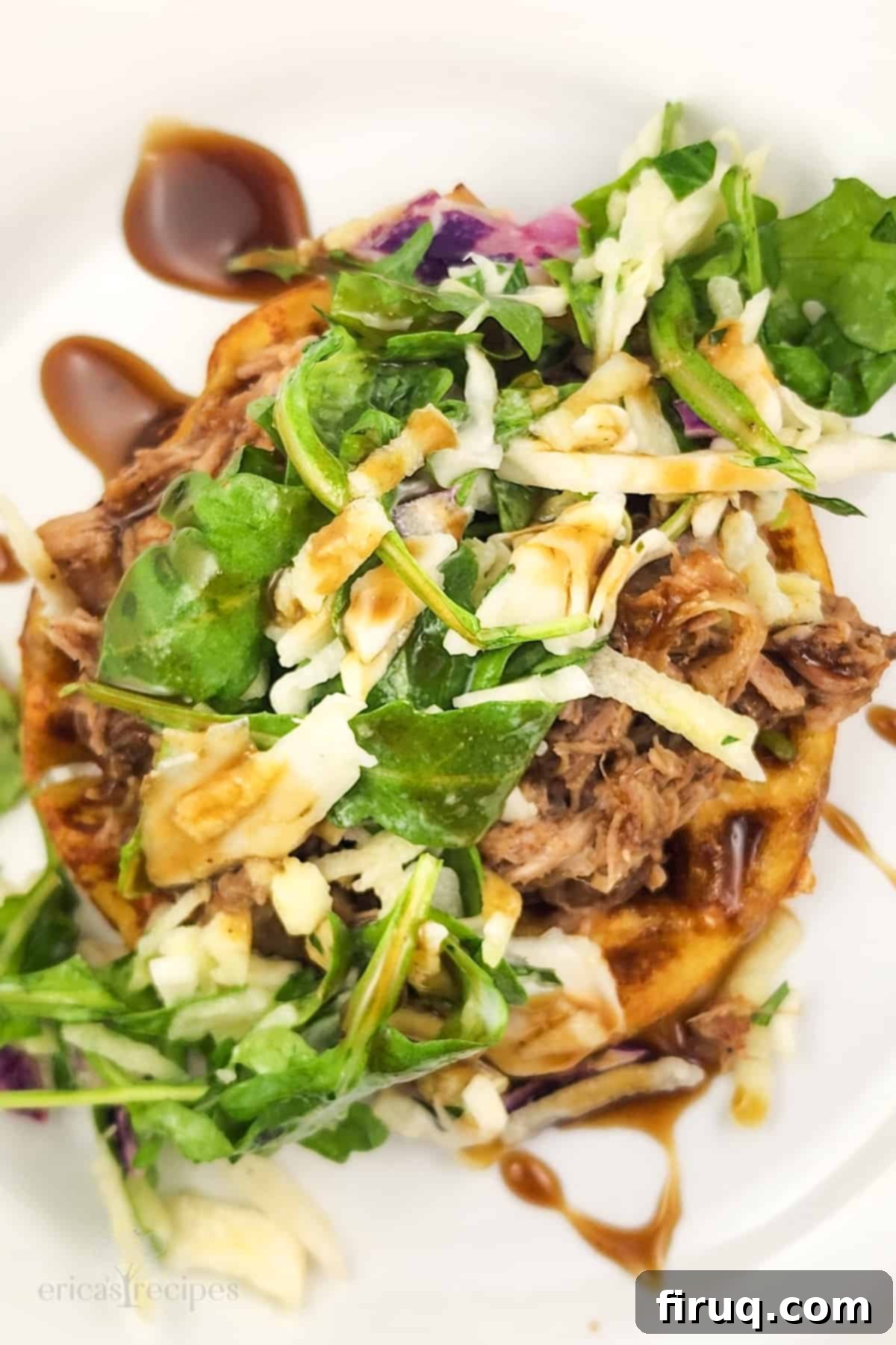 Whiskey-Glazed Pulled Pork on Golden Waffles 5 top-down view of prepared pork and waffles recipe on white plate with cutlery, ready to be eaten