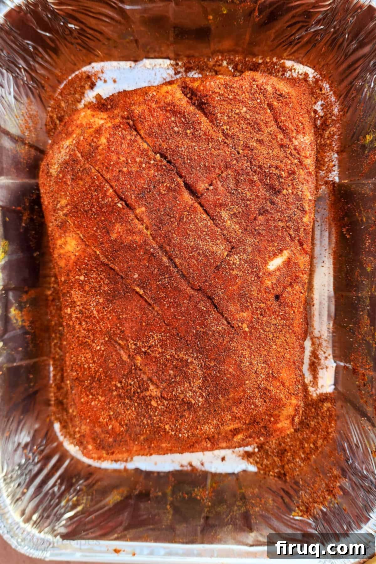 The Ultimate Juicy Smoked Pulled Pork from Your Big Green Egg 3 Boston butt seasoned with mustard and rub, ready for smoking