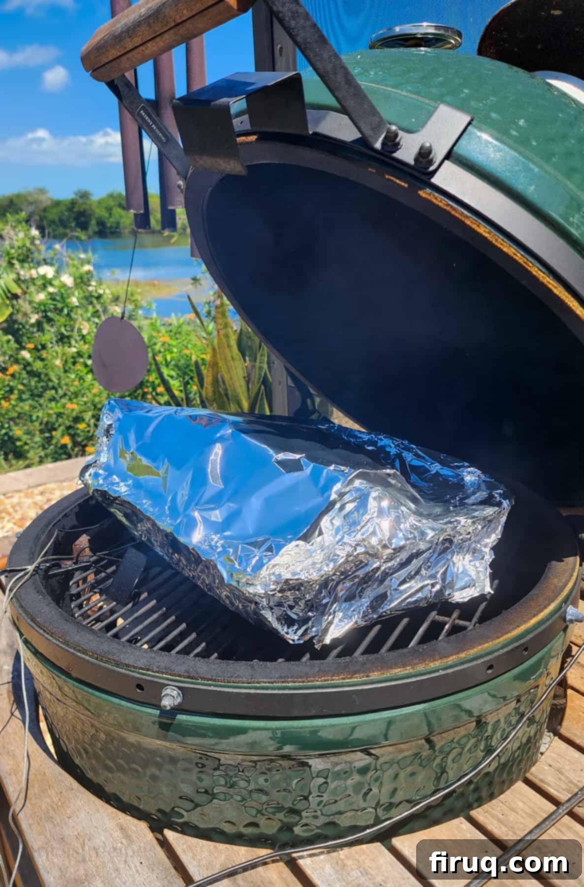 The Ultimate Juicy Smoked Pulled Pork from Your Big Green Egg 5 Foil-wrapped Boston butt cooking in a pan on the Big Green Egg