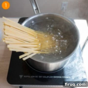 Classic Fettuccine Alfredo 4 Boiling fettuccine in a large pot of salted water.