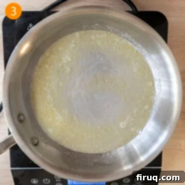 Classic Fettuccine Alfredo 6 Combining starchy pasta water with melted butter in a pan.