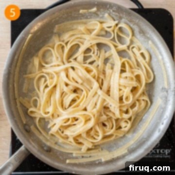Classic Fettuccine Alfredo 8 Adding freshly grated Parmigiano-Reggiano cheese to the pasta in the pan, off the heat.