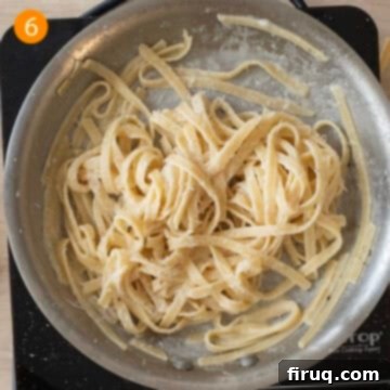 Classic Fettuccine Alfredo 9 Finished creamy fettuccine alfredo with a perfect emulsion, ready to be served.
