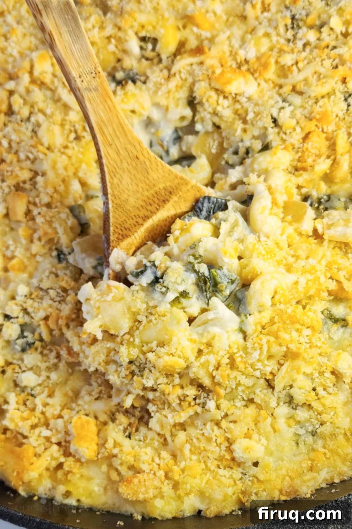 Velvety Poblano Mac and Cheese 2 Wood spoon inserted into creamy poblano mac and cheese, showing rich texture and roasted peppers