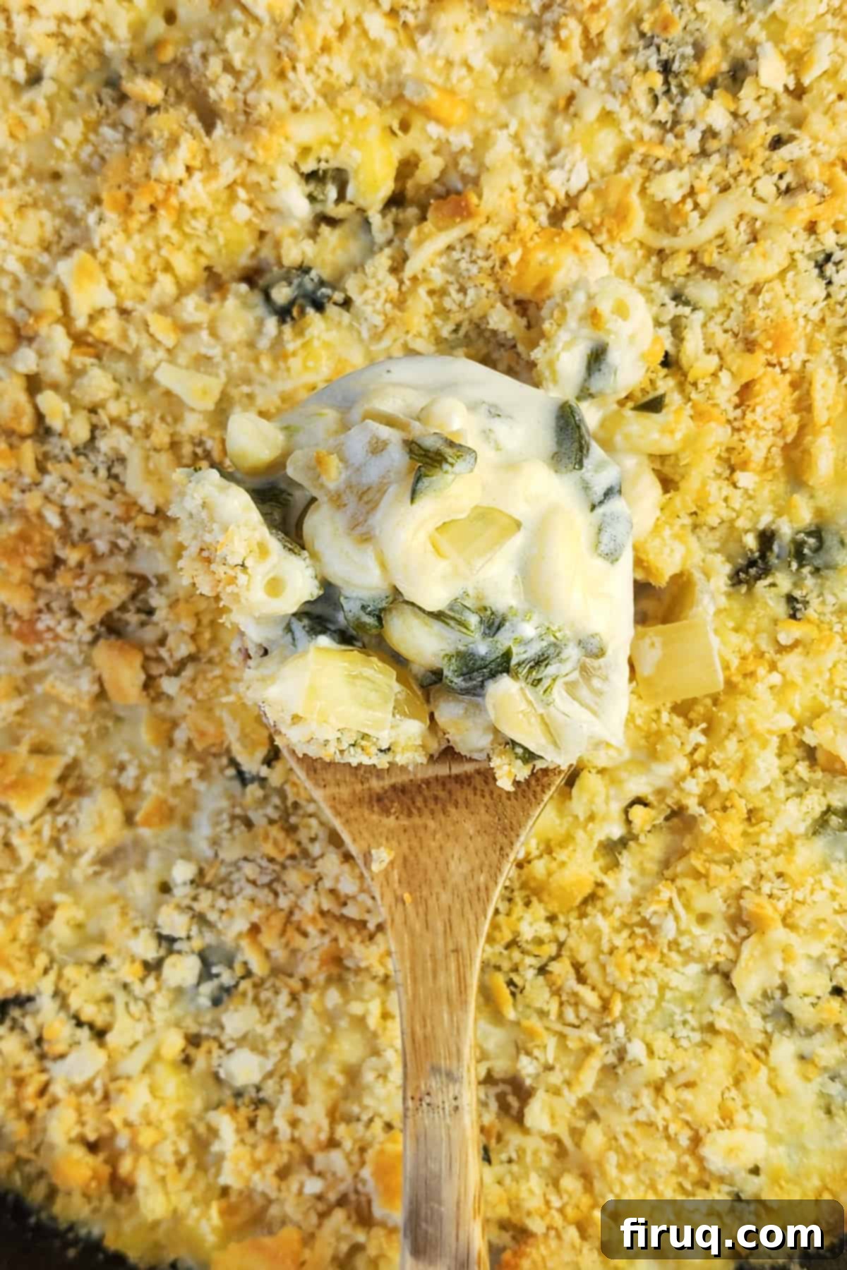 Velvety Poblano Mac and Cheese 3 Spoon lifting a generous portion of poblano mac and cheese from a baking dish