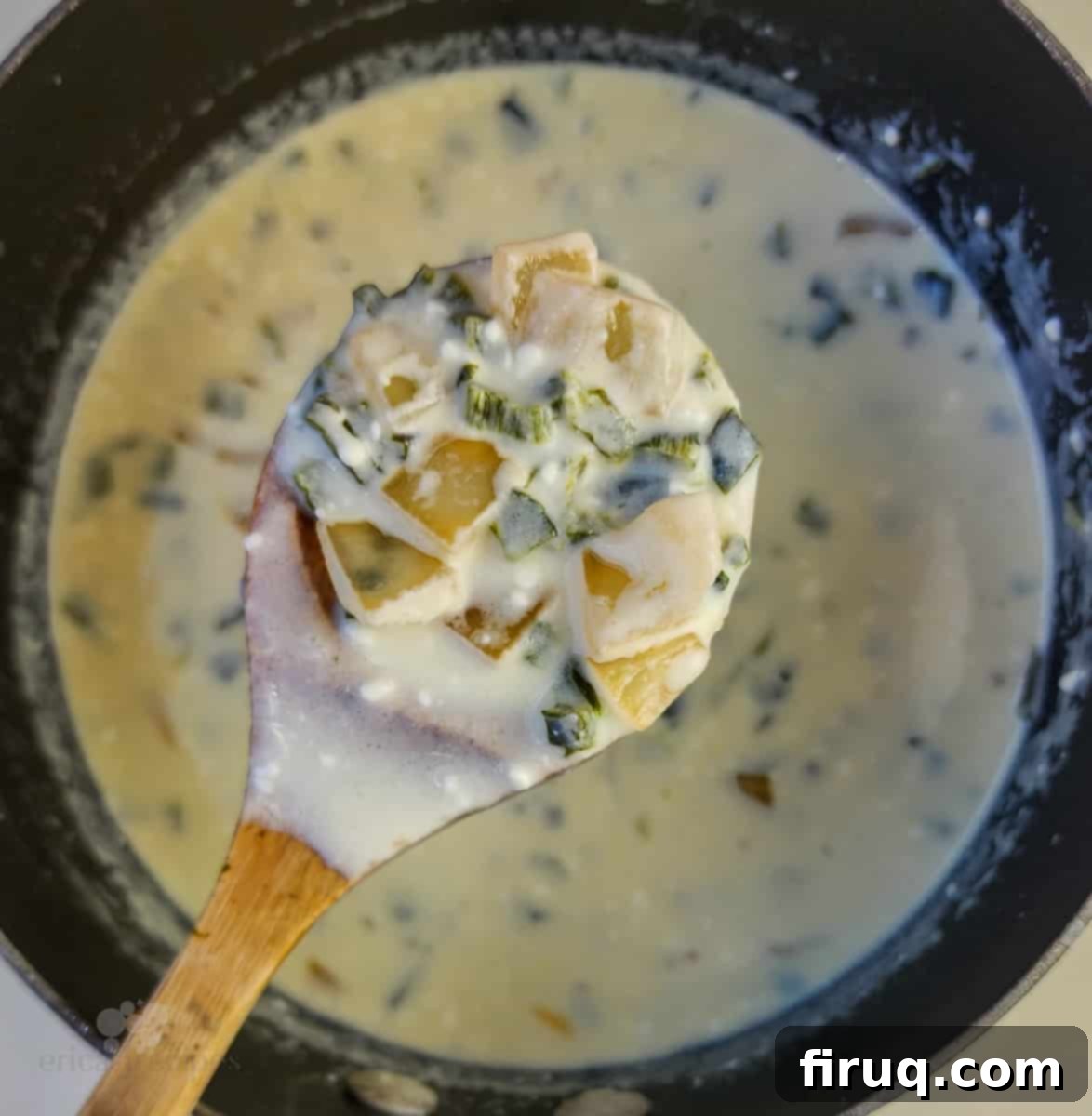 Velvety Poblano Mac and Cheese 7 Spoon holding creamy cheese sauce over a saucepan