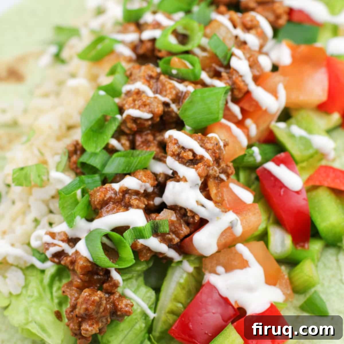 Game-Changing Ground Beef Tacos 2 ground beef taco meat atop veggies and rice topped with ranch dressing
