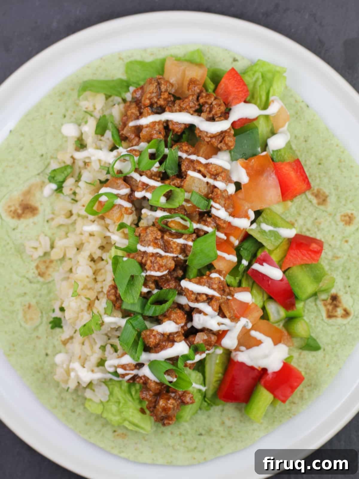Game-Changing Ground Beef Tacos 7 taco meat, veggies, and rice on top of spinach tortilla wrap topped with ranch dressing