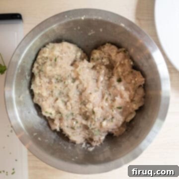 Gourmet Gorgonzola Grilled Chicken Burger 4 Ground chicken combined with finely chopped parsley, crumbled gorgonzola cheese, breadcrumbs, salt, and pepper in a large mixing bowl.