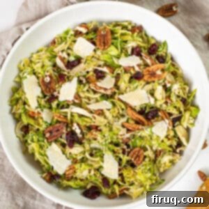 Brussels Sprout Salad with Crispy Pancetta 12 Brussels sprouts salad in a bowl topped with dried cranberries and pecans.
