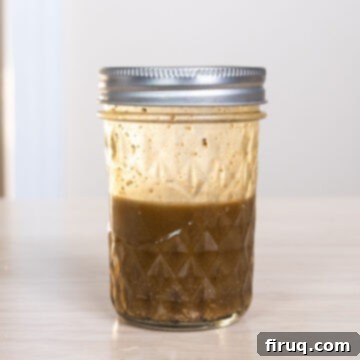 Brussels Sprout Salad with Crispy Pancetta 5 Dressing in a mason jar.