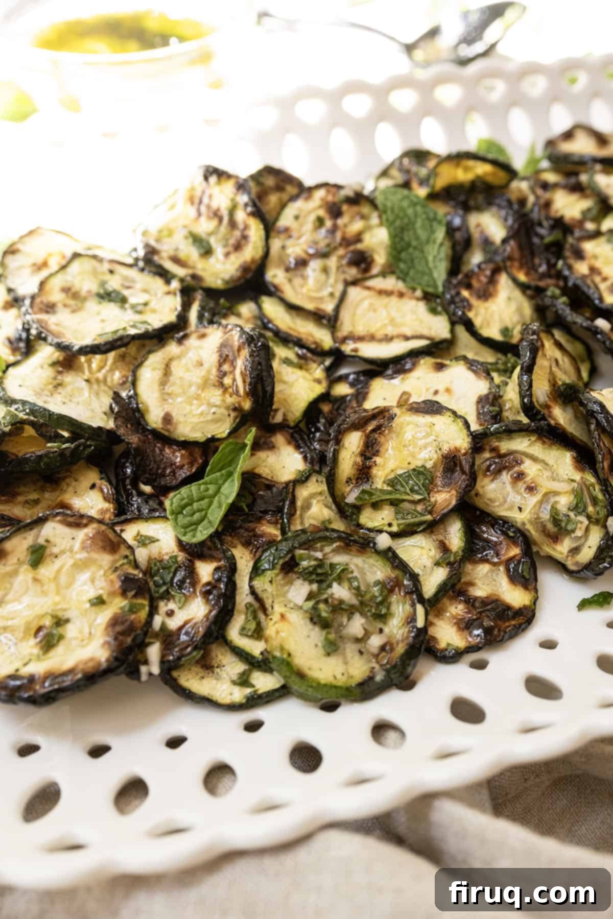 Zesty Marinated Zucchini 2 Zucchini alla scapece on a tray garnished with fresh mint leaves, ready to be served.