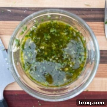 Zesty Marinated Zucchini 4 A small bowl containing a vibrant green mint and garlic vinaigrette dressing.