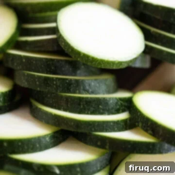 Zesty Marinated Zucchini 5 Evenly sliced zucchini pieces, approximately half an inch thick, ready for grilling.