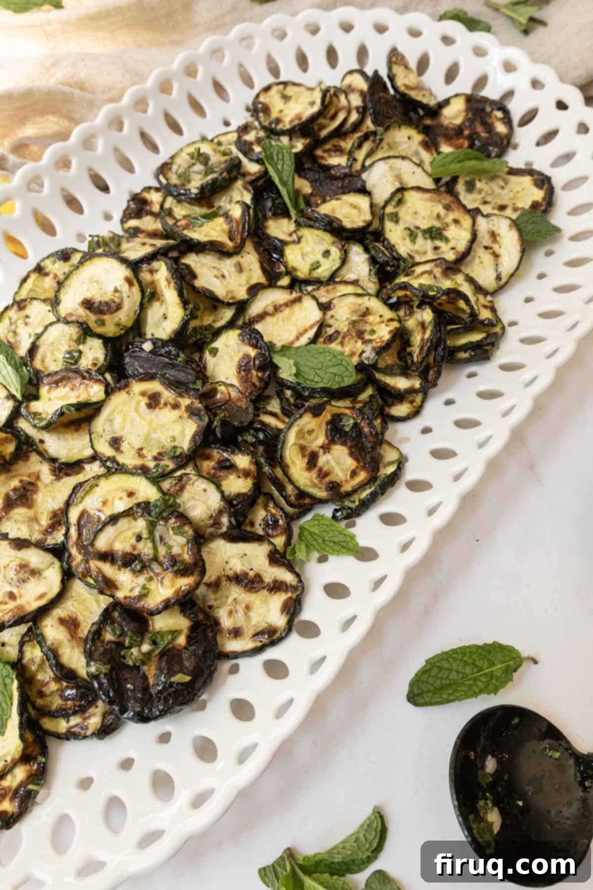 Zesty Marinated Zucchini 9 Platter of Zucchini alla Scapece, beautifully garnished with fresh mint, ready to be enjoyed.