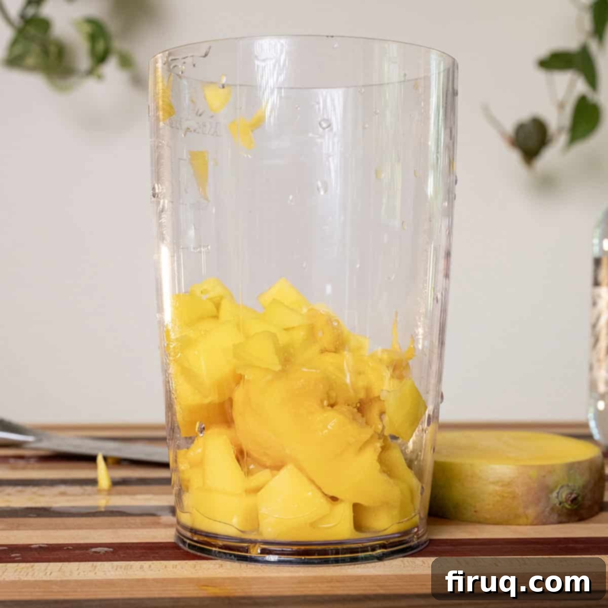 Blazing Mango Margarita 4 Fresh mango chunks inside a blender cup, ready to be pureed for the margarita.