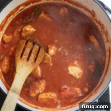 Spicy Chicken Rigatoni 11 Chicken pieces simmering in the rich tomato sauce, allowing flavors to meld.