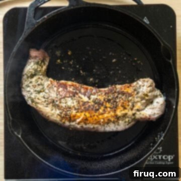 Rustic Italian Cast Iron Pork Tenderloin 6 Pork tenderloin flipped on cast iron pan, searing the opposite side to lock in juices.