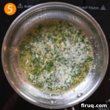 Ultimate Air Fryer Parmesan Chicken 8 Garlic butter sauce in a pan with parsley.