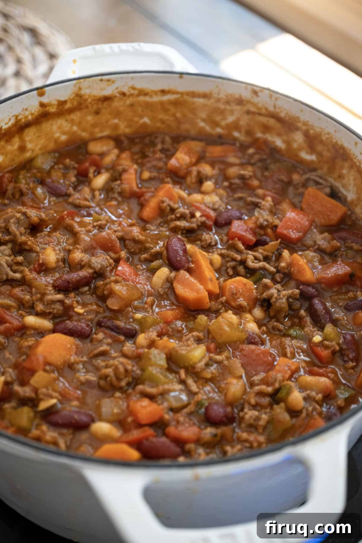 Golden Harvest Chili 12 Pumpkin chili simmering in a Dutch oven, ready to be served.