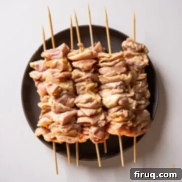 Irresistible Garlic Parmesan Chicken Skewers 5 Marinated chicken thighs on skewers.