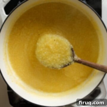 Velvety Smooth Polenta 6 Thickening polenta in a pot, being stirred with a wooden spoon as it nears completion.