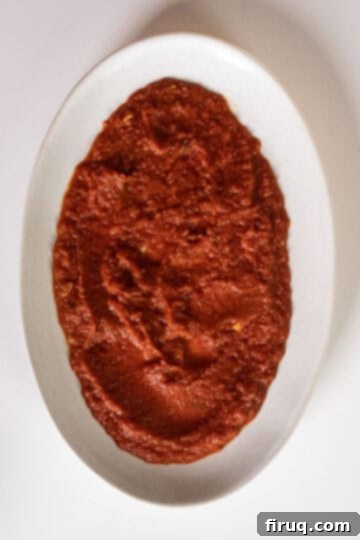 Golden Grilled Polenta with Marinara and Pesto 9 A serving plate with a generous base of rich, red marinara sauce, ready for grilled polenta.