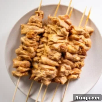 Zesty Bang Bang Chicken Skewers 8 Marinated chicken pieces threaded onto a skewer, ready for the grill.