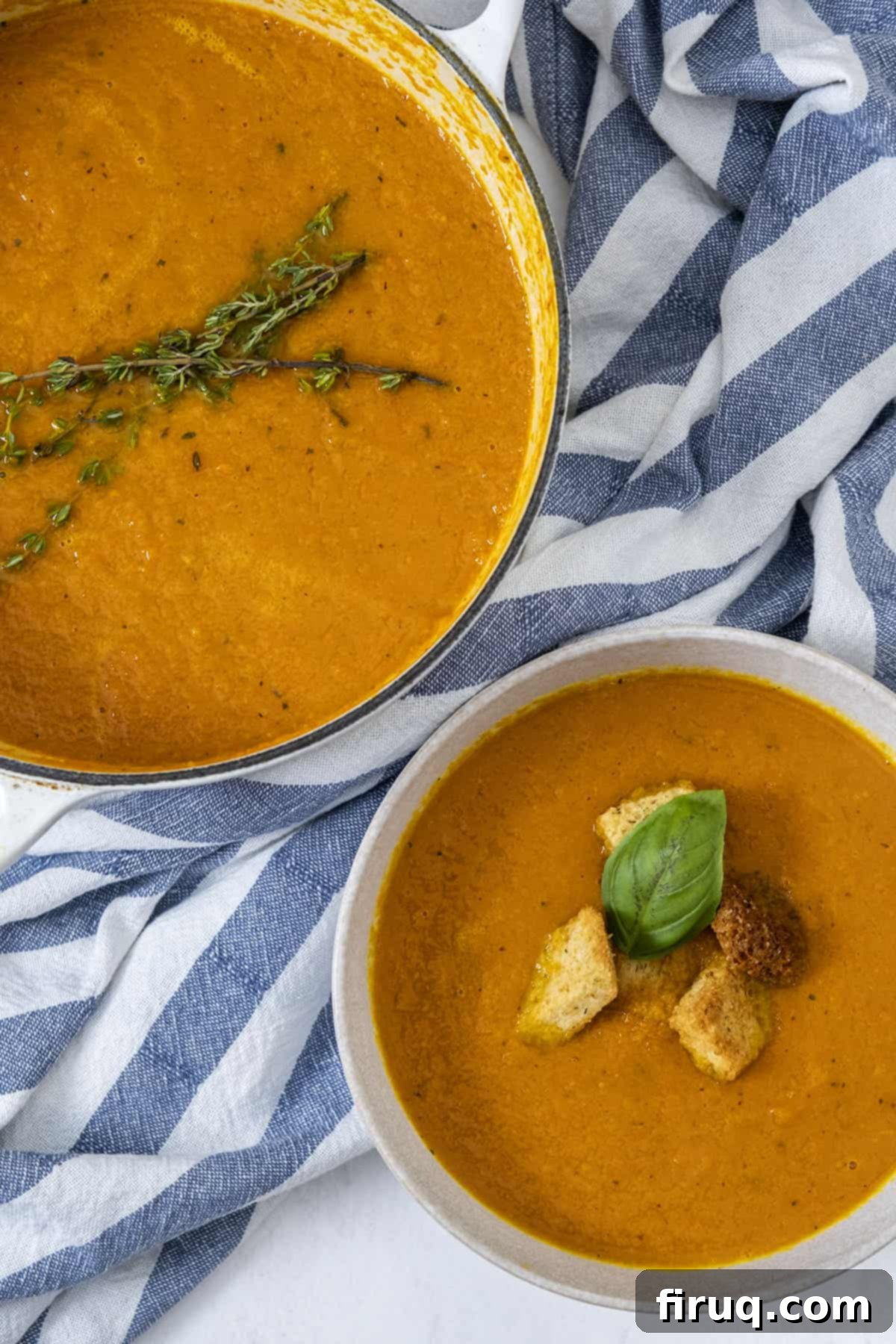 Velvety Roasted Carrot Ginger Soup 2 Roasted Carrot ginger soup in dutch oven and bowl, topped with crutons, thyme, and basil