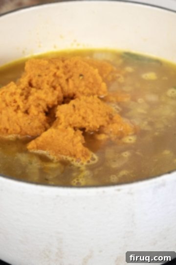 Velvety Roasted Carrot Ginger Soup 7 carrots poured into broth