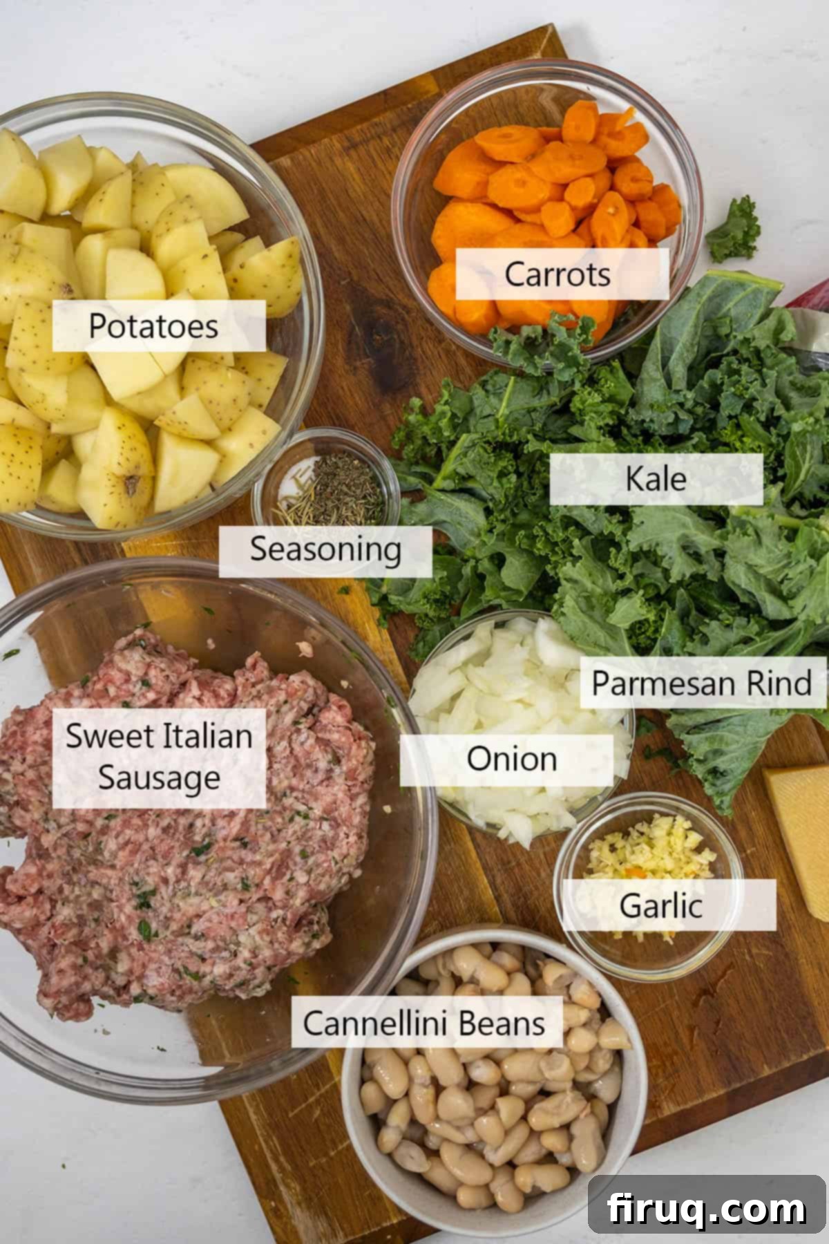 Creamy Tuscan Sausage and Potato Soup 3 A collection of fresh ingredients laid out for Zuppa Toscana, including sausage, potatoes, kale, carrots, and onions.